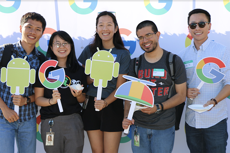 Group of students holding Google signs