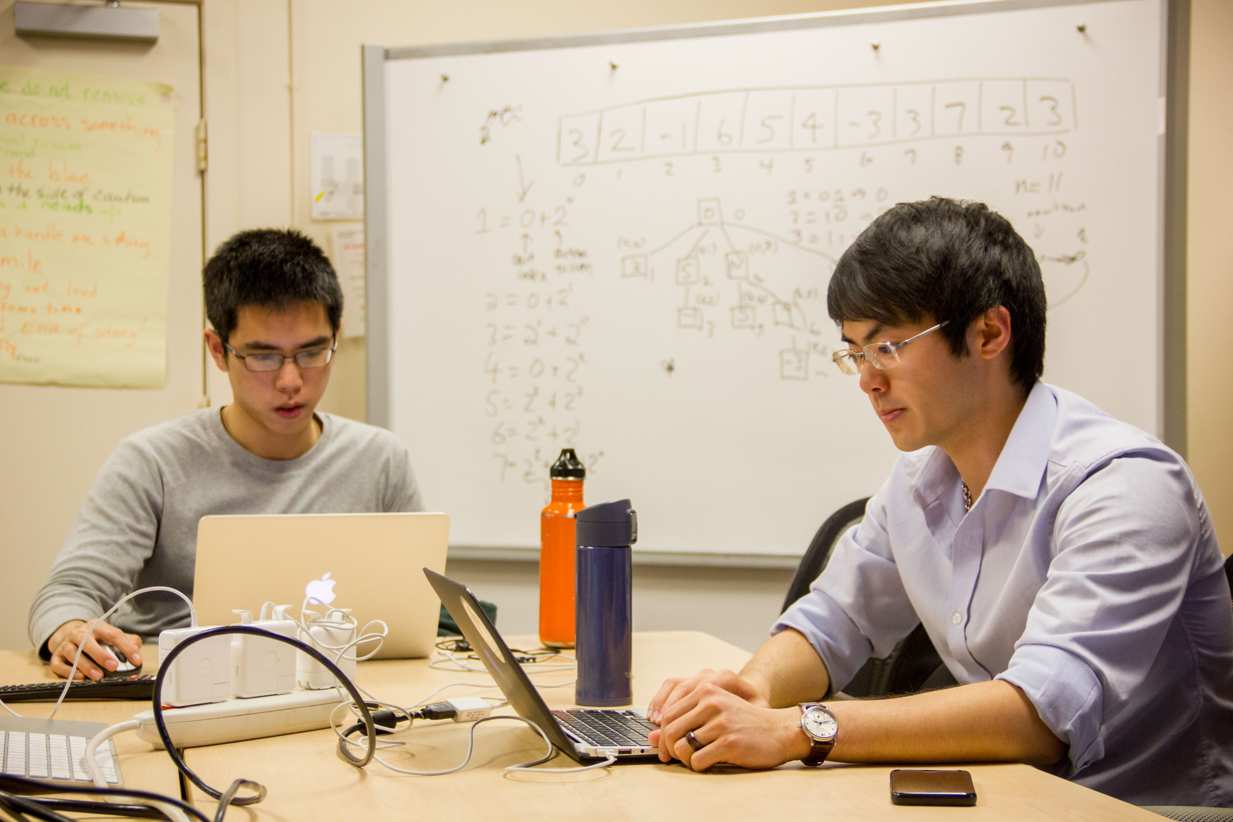 Students work on either their computers or on the whiteboard