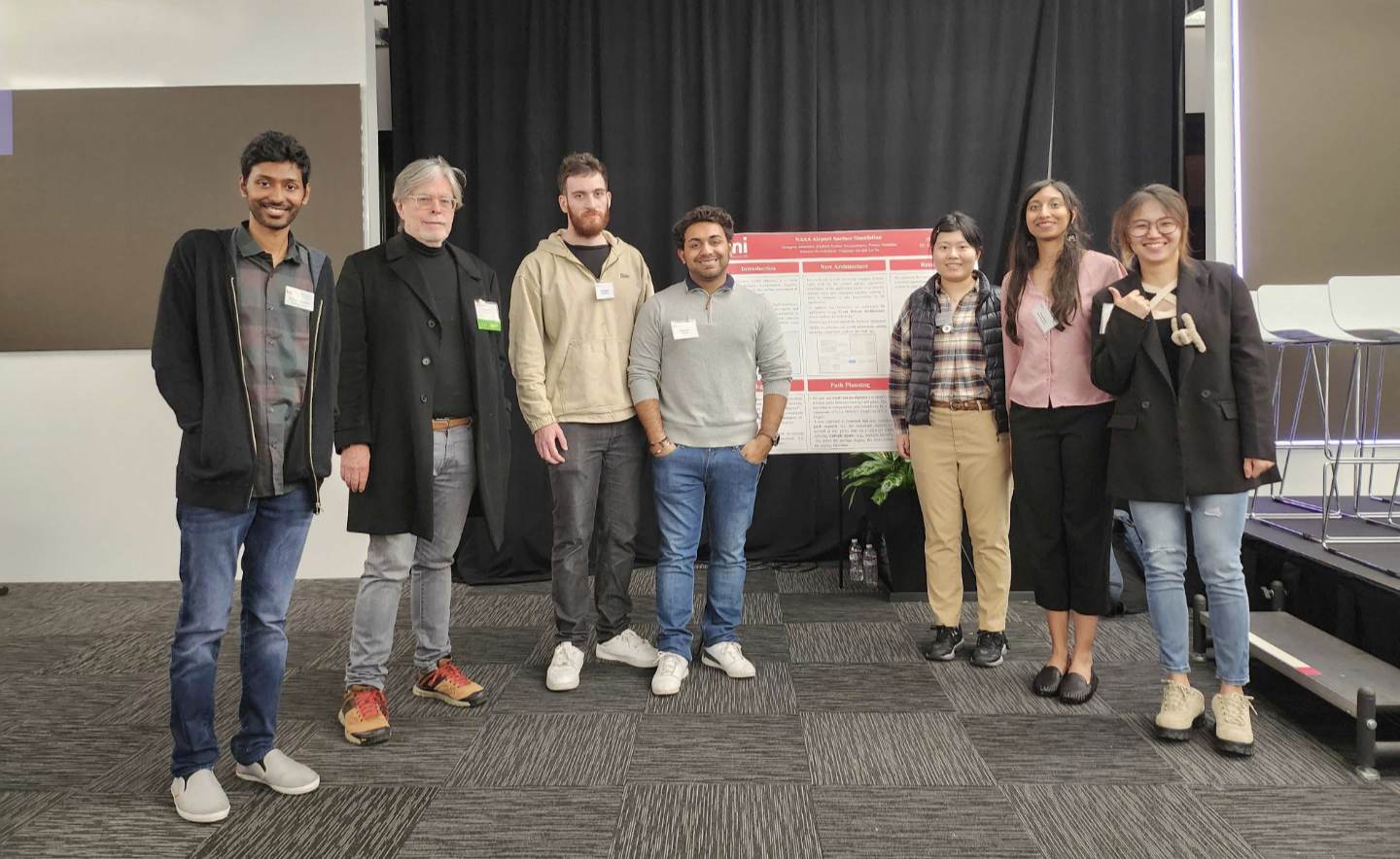 group of people standing by a presentation