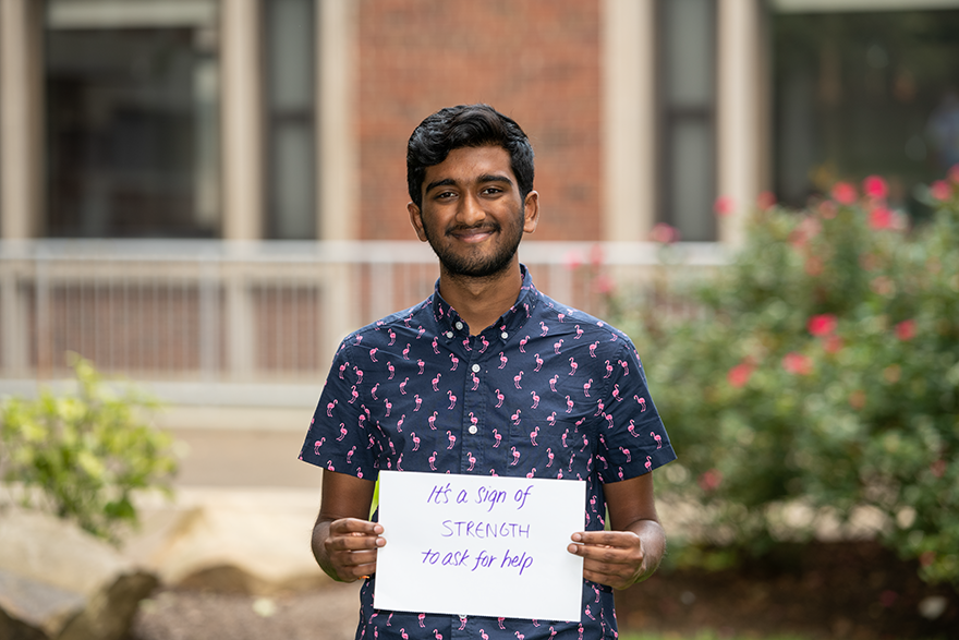 student holding sign